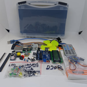Arduino Starter Kit - components laid out including a blue microcontroller board, LCD screen, motor with fan, remote, sensor modules, and LED bags.