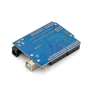 Arduino Uno With USB Cable SMD - a blue circuit board from the bottom, featuring a DC power jack, a USB port, and pin header solder points.