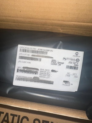 ATMEGA328P-U Microcontroller | High-performance MCU | Digilog.pk - shown as a bulk quantity of 560 units inside a sealed black anti-static bag with a Microchip product label.