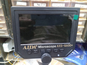 AXS-G600+ 4.3 Inch Screen 600x Zoom Microscope - a black 4.3-inch display, a row of five control buttons, and a central adjustment knob on the front panel.
