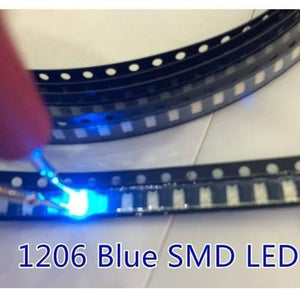 Blue SMD 1206 LED Super Bright Light Emitting Diode - shown as a bright blue light being tested with probes while seated in a black carrier tape reel.