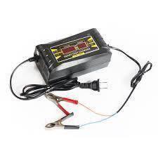 Car Charger Portable Car Battery Charger With Digital Display (SON-1206D) - a black portable device with a digital display, an attached power cord, and two alligator clips connected by wires.
