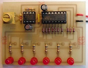 CD4017 IC - featured on a populated circuit board with a 555 timer, a yellow potentiometer, six red LEDs, resistors, and diodes.