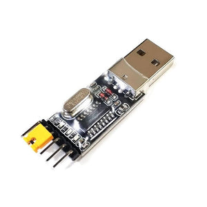 CH340G USB To TTL(serial) Converter For Arduino Nano Raspberry Pi - a black circuit board with a silver USB-A connector on one end and four male header pins with a yellow jumper on the other.