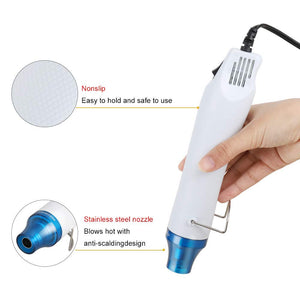 Compact 300W Mini Heat Gun – Portable Craft Heat Tool For DIY, Embossing, Paint Drying & Shrink Wrap - shown in a hand with callouts highlighting its white nonslip textured handle and blue stainless steel nozzle.