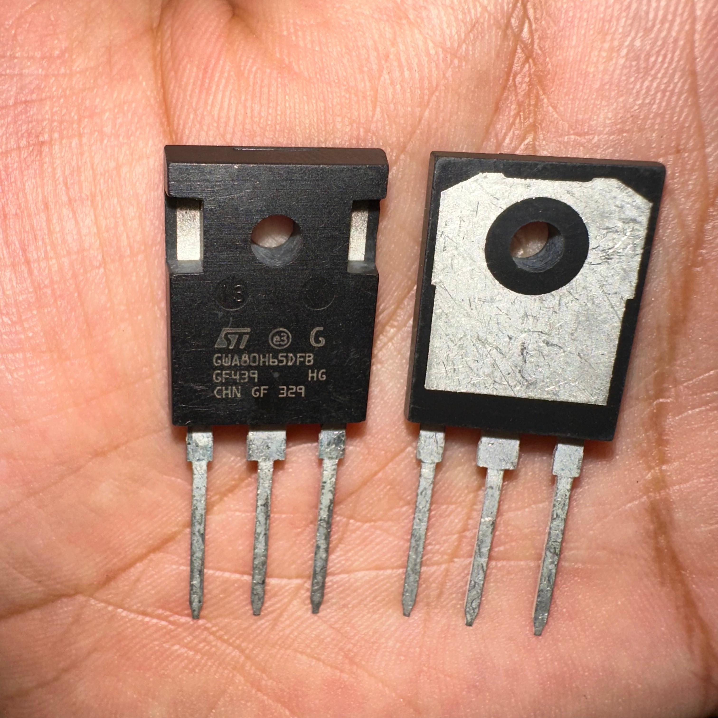 Copy 80N65 GW80H65 80H65 IGBT - two black three-pin semiconductor components held in a hand, showing the front markings and the rear metal heat sink.