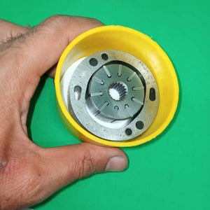 Danny Pump Cartridge 34079623001 - a close-up view of a metallic pump rotor with a splined center held inside a yellow plastic protective casing.