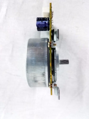 DC 24V 1A Stepper Motor B417 6282A DNQ12A83R08A - the cylindrical metal motor body, circuit board, capacitors, and a gear-toothed shaft.