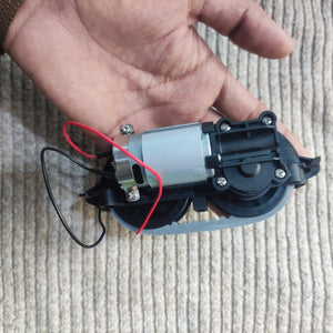 DC Gear Motor With 3.7V To 12V Operated - a silver cylindrical motor attached to a black plastic gearbox with a grey rubber drive belt.