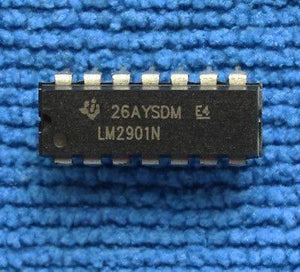 Differential Comparator IC LM2901N - a black 14-pin dual-in-line integrated circuit chip with white text markings, resting on a blue textured surface.