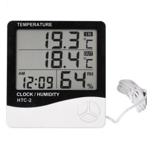 Digital Thermometer And Hygrometer Htc-2 - a black and white device with a digital display reading 19.3°C IN, 18.4°C OUT, 12:09 AM, and 64% RH.