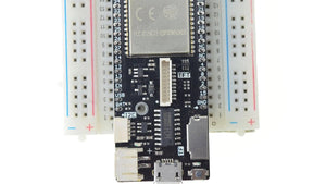 Discontinued Lolin D32 Pro V2.0.0 - WiFi & Bluetooth Board Based ESP-32 ESP32 REV1 ESP32-wrover 16MB 8MB 4MB Flash Psram Micropython - a black ESP32 development board with a metal shield, mounted on a white breadboard, featuring a micro-USB port and connectors.