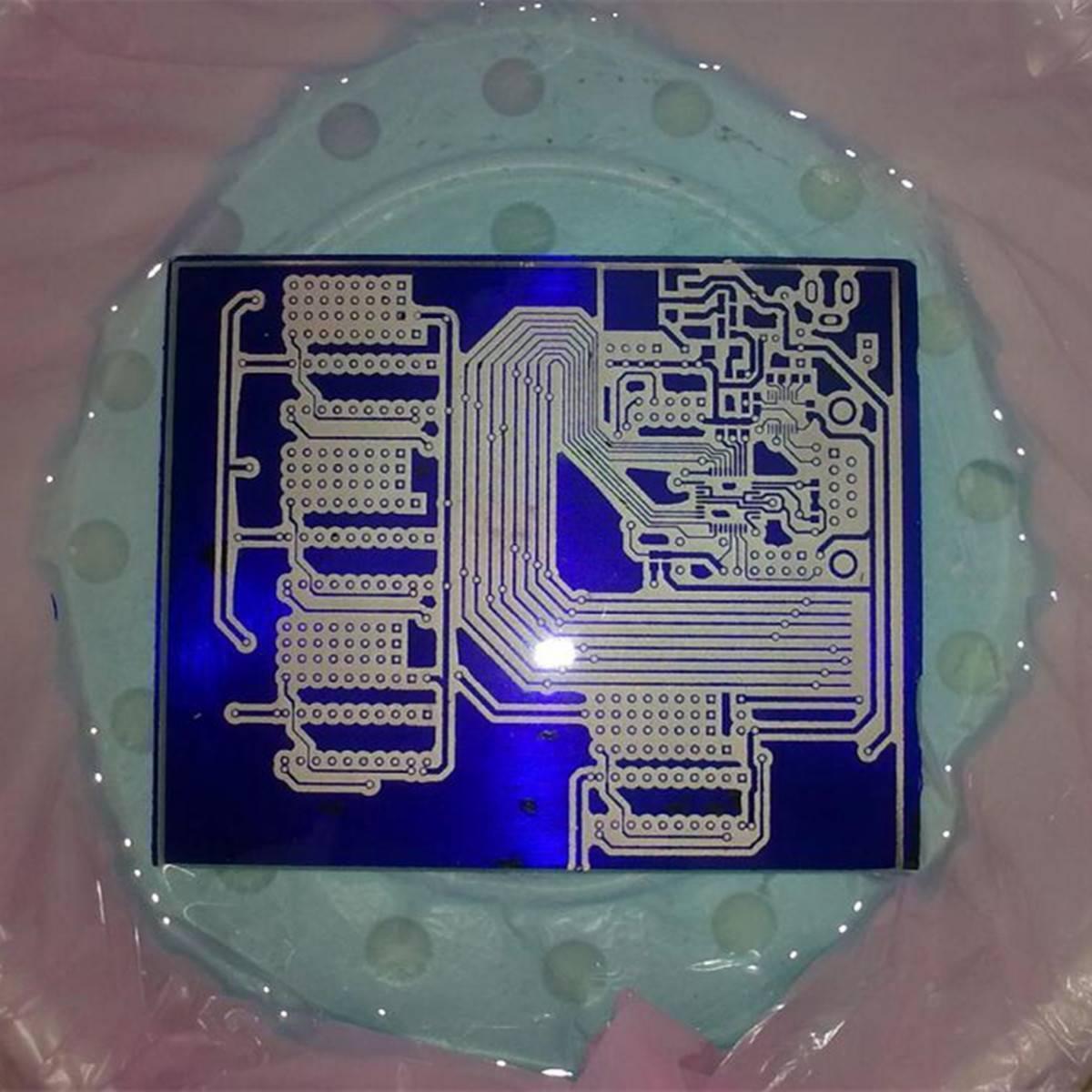 Discontinued Photo Resist Photosensitive Dry Film 30cm 1 Meter Photoresist - a rectangular blue sheet with a white printed circuit board pattern resting on a light blue base.
