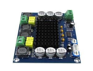 Discontinued XH-M543 TPA3116D2 Dual-channel Class D Digital Audio Power Amplifier Board 50W*2 - a blue circuit board with a black heatsink, green screw terminals, and silver capacitors.