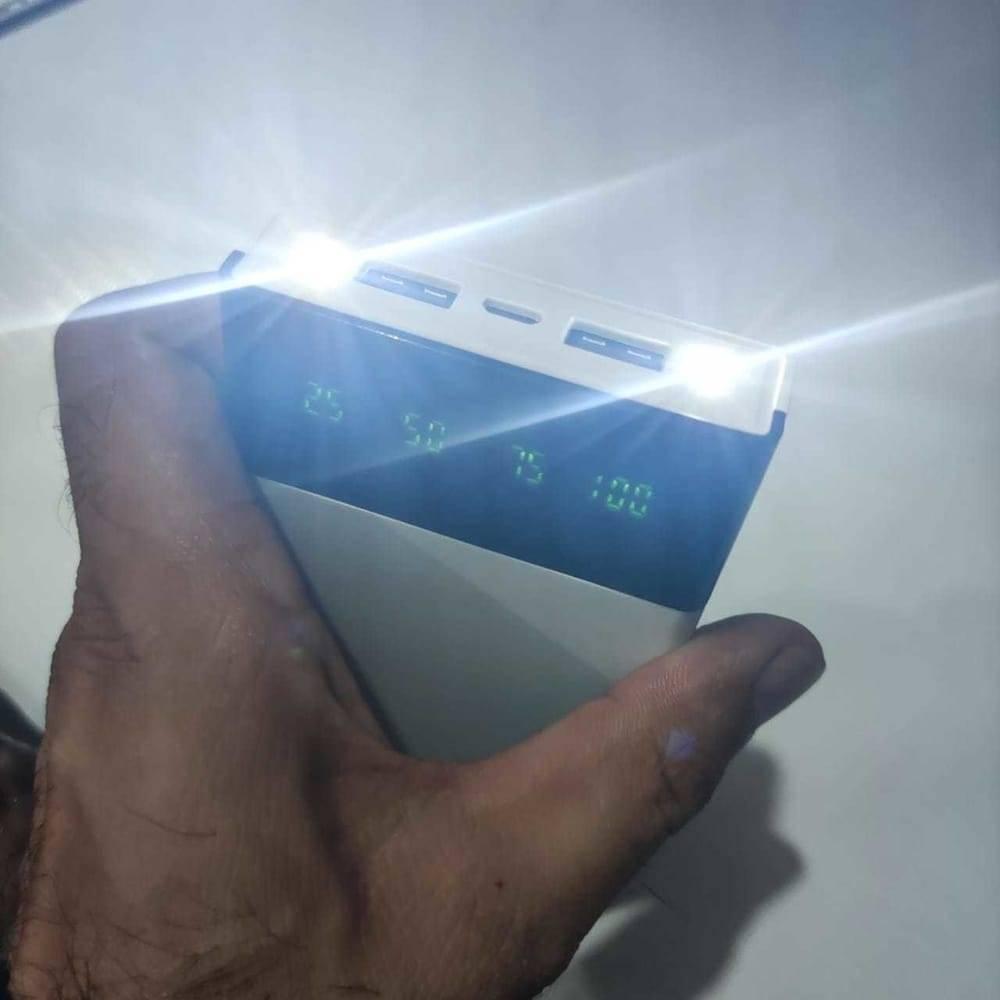 DIY 5V 2A Dual USB Power Bank Case With Power Bank Kit - white handheld device with two illuminated LED lights, two USB ports, and a digital display showing 25, 50, 75, 100.