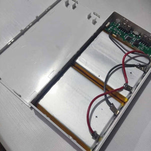 DIY 5V 2A Dual USB Power Bank Case With Power Bank Kit - shown open, revealing two silver battery cells connected to a green circuit board with two USB ports.