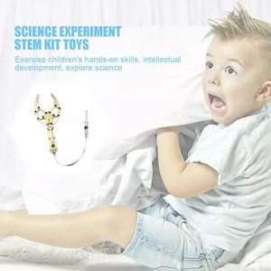 DIY Hydraulic Manipulator Wooden STEM Kit Unassembled - a light-wood claw mechanism connected by a clear tube to a syringe control.