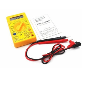 DT830D Digital Multimeter - a yellow handheld device with a rotary knob, digital display reading 000, instruction manual, and red and black probes.