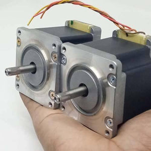 Dual Shaft NEMA 23 2A Stepper Motor For CNC 3d Printer - two silver and black metal stepper motors with knurled shafts held in a hand against a white background.