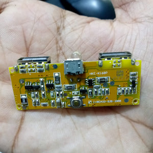 Dual USB 18650 Battery Charger Power Bank Module 5V 1A 2A - a yellow rectangular circuit board with two USB ports, a micro-USB port, and a button.