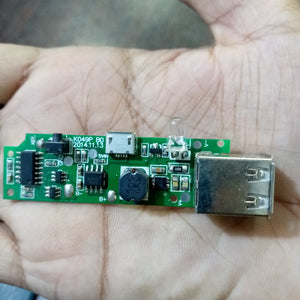 Dual USB Power Bank Module - shown as a green circuit board with a micro-USB port, a USB-A port, an LED light, and a push-button switch.