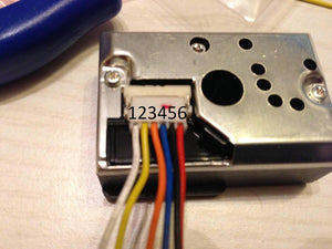 Dust Sensor Module GP2Y1010AU0F Compact Optical Dust Sensor - a close-up of the metallic sensor housing with a six-pin white connector and attached multi-coloured wiring harness.