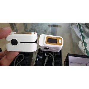 Finger Pulse Digital Oximeter-SPO2 - two white and gold devices with display screens, buttons, and lanyards inside their open packaging boxes.