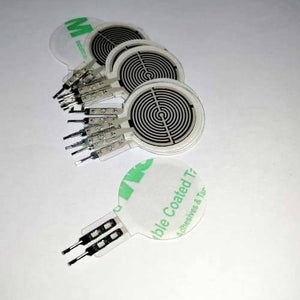 FSR402 Force Sensitive Resistor Fsr - a stack of circular white sensors with black spiral patterns and two-pin connectors on a white background.