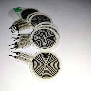 FSR402 Force Sensitive Resistor Fsr - a stack of several circular white pressure sensors with black spiral patterns and two-pin metal connectors.