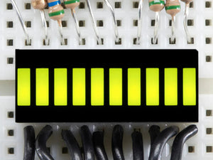 Green 10 Segment Light Bar Graph LED Display - ten illuminated yellow-green rectangular segments mounted on a white breadboard with wires.