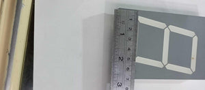 Green color 7 segment - shown in a close-up view with a metal ruler placed along the side to indicate its dimensions.