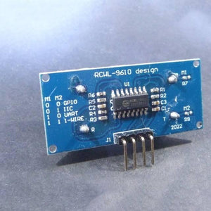 HC-SR04 Hc SR04 Arduino Ultrasonic Sensor - RCWL-9610 ultrasonic sensor module, showing a blue rectangular circuit board with a central chip, surface-mount components, and a four-pin header.