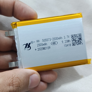 Hh 505573 LiPo Battery 2500mAh 3.7V For Laptop Battery Replacement - a rectangular silver lithium-polymer battery with yellow tape edges and two metal contact tabs held in a hand.