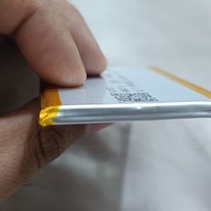 Hh 505573 LiPo Battery 2500mAh 3.7V For Laptop Battery Replacement - a close-up side view showing a thin, rectangular silver battery cell with yellow taped edges and a QR code.