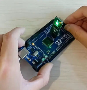 Hiata Arduino Mega Bootloader Burner Offline Standalone Isp Programmer - shown being held and connected to a blue Arduino Mega board with an active LED.