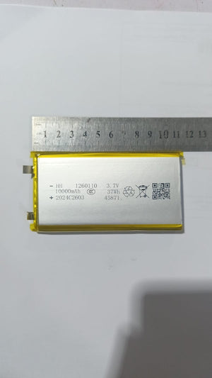 High Quality 3.7V 10000mAh 1260110 Polymer Lithium Ion Li-ion Rechargeable Battery For Toy Power Bank GPS Table E-book Batteries - shown with a metal ruler measuring its length, displaying technical specifications and a QR code on its silver surface.