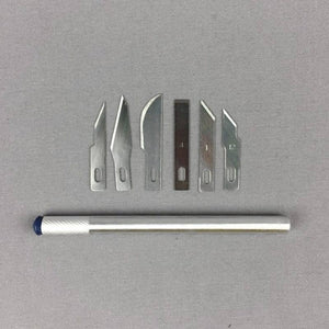 Hobby Knife Set 7pc - a silver metal handle and six assorted interchangeable steel blades arranged on a grey background.
