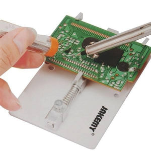 Jakemy Mobile Phone Motherboard Circuit PCB Board Holder Clamp Stand JM-Z15 - a white base holding a green circuit board while being soldered.
