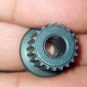Japanese GT2 20 Teeth 5mm Bore Push Fit Pulley Timing Pulley - shown in a close-up view held between fingers, featuring a dark grey, circular, toothed design.