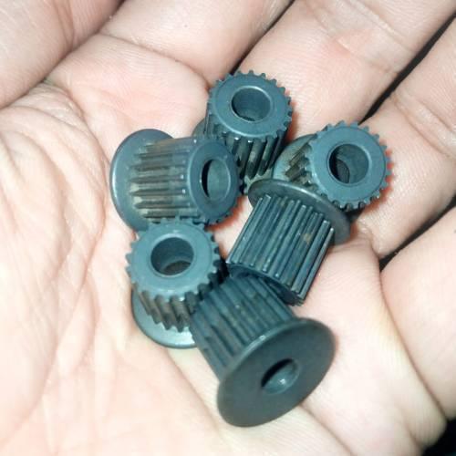 Japanese GT2 20 Teeth 5mm Bore Push Fit Pulley Timing Pulley - shown as a close-up of several grey, cylindrical, toothed pulleys held in a hand.