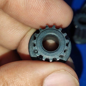 Japanese GT2 3mm Teeth Size 15 Teeth 6.3mm Bore Push Fit Pulley Timing Pulley - a close-up shot of a small black circular gear being held between two fingers.