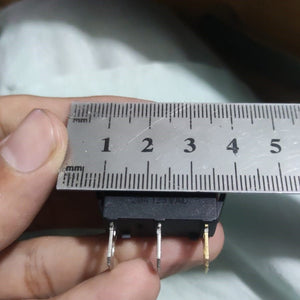 KCD3-104N Red Light 3pin Spst On And Off Rocker Switch - shown in a close-up view being measured with a metal ruler against its three terminal pins.