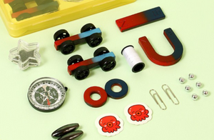 Kids STEM School Learning Magnet Power Kit - Science Experiment D - a collection of magnets, two toy cars, a compass, paperclips, metal balls, and octopus-themed stickers.
