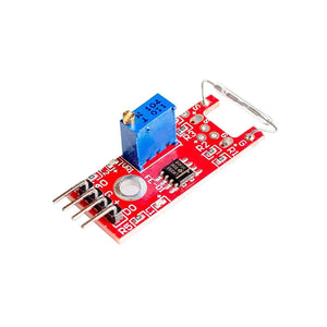 Ky-025 Reed Switch Sensor - module on a red PCB with a blue potentiometer, a glass reed switch, an LM393 chip, and four output pins.