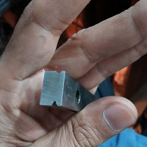 Linear Bearing Slide Rail CNC Router - close-up of a small, rectangular silver metal component with a central groove and a circular hole.