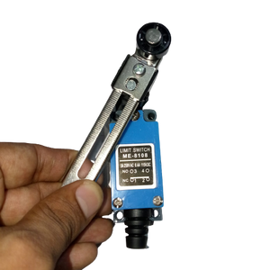 Me-8108 Mini Limit Switch - held in a hand, featuring a blue rectangular body with a metal roller lever arm and a label showing terminal numbers 1, 2, 3, 4.