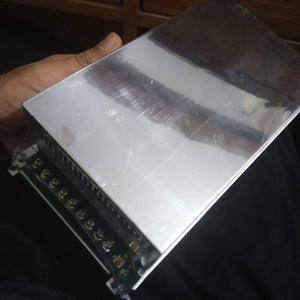 Mean Well Meanwell 24V 20A Switch Mode Power Supply 24V 20.8A - shown as a silver rectangular metal unit held in a hand with a terminal block featuring screw connectors.