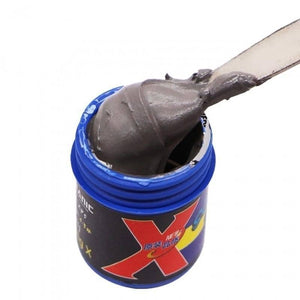 Mechanic Flux Solder Paste 40G 148 Degree XP5 - shown in a blue jar with a metal spatula scooping out a portion of the dark grey paste.