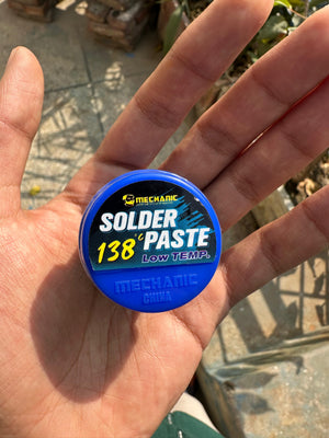 Mechanic LW50 Solder Paste 138°c Low Temp 50G - shown as a small, round blue container held in a hand, with the product name and temperature printed on top.