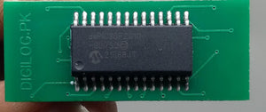 Microchip DSPIC30F2010 Microcontroller - 14-bit DSC with DSP - a black integrated circuit chip soldered onto a green rectangular printed circuit board with visible traces.